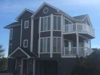 Dark blue three-story home