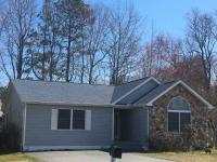 Small, mid-class home with a gray shingle roof